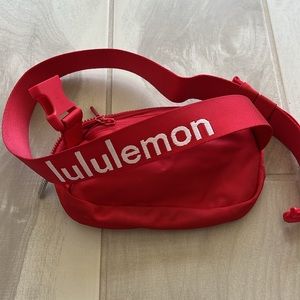 Lululemon red belt bag with lululemon on strap